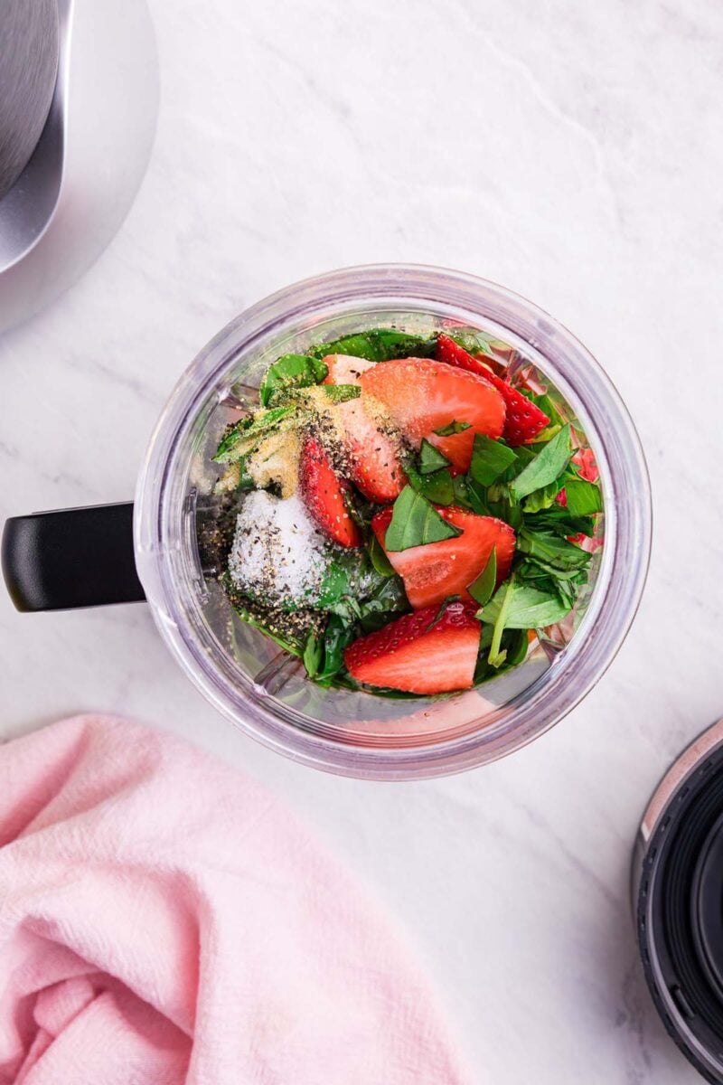 Ingredients for strawberry vinaigrette in a blender before blending.