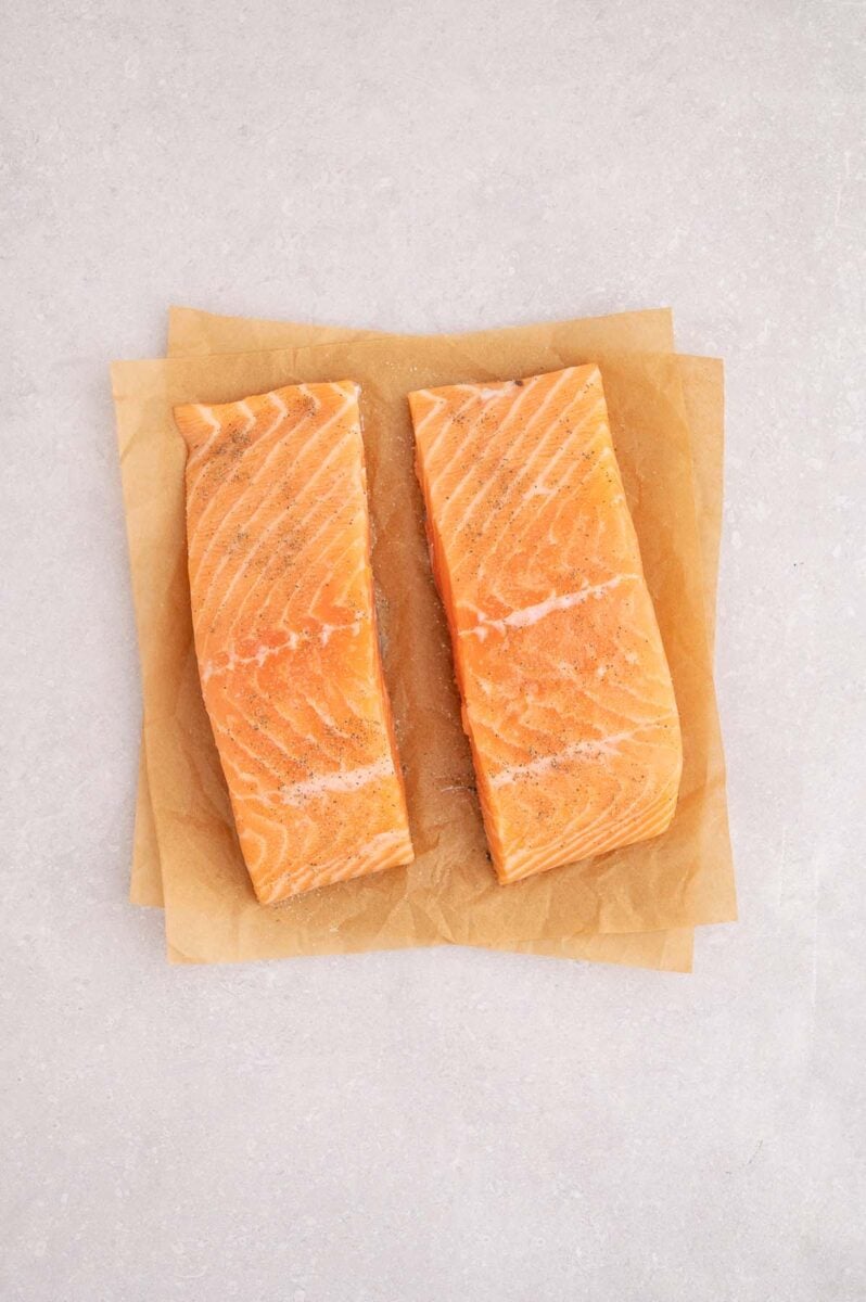 Salmon filets seasoned with salt and pepper.