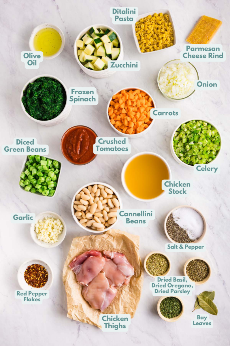 Labeled ingredients to make chicken minestrone soup in small bowls and measuring cups.