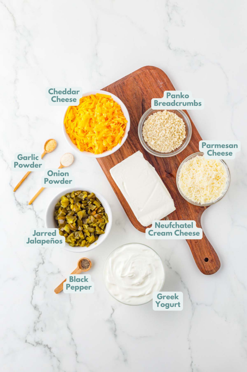Labeled ingredients to make jalapeno popper dip in small bowls and measuring cups.