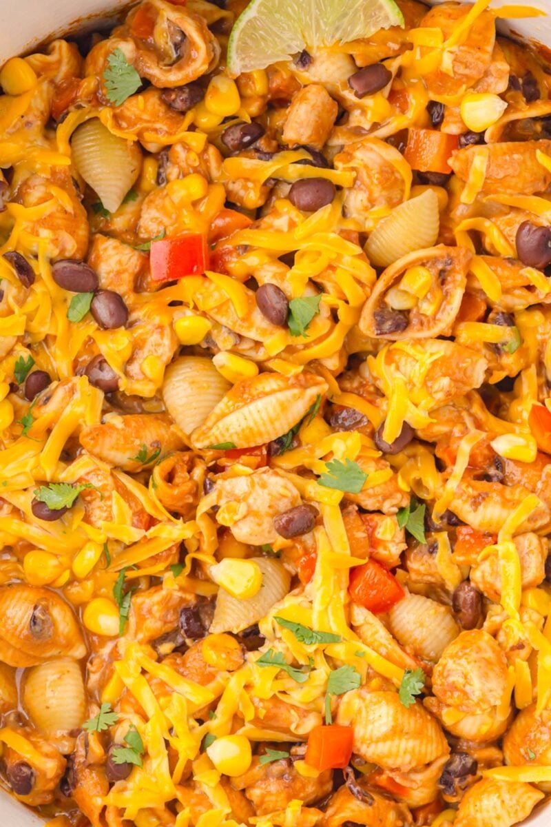 A close up of chicken taco pasta with a lime slice.