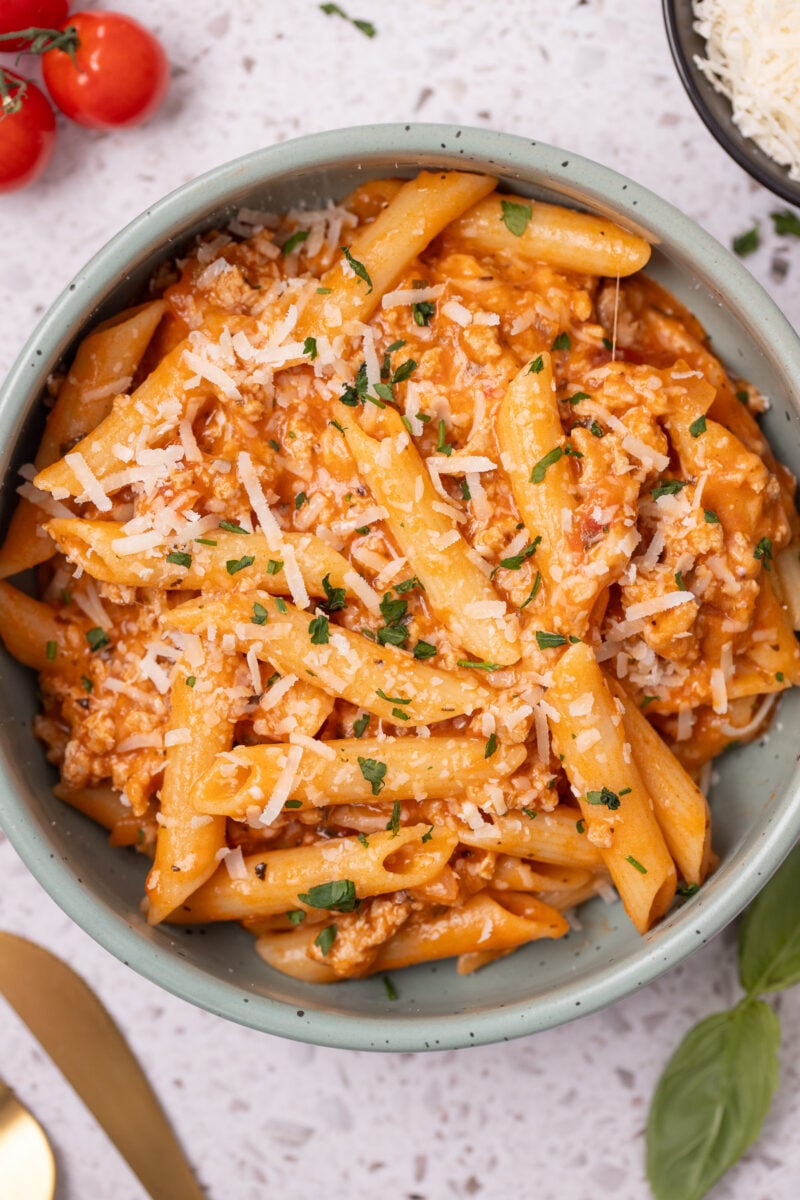 A close up of cheesy Ground Turkey Pasta in a bowl.