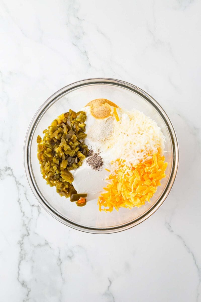 Ingredients for healthy jalapeno popper dip in a large glass bowl.