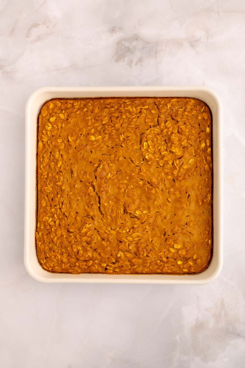 Pumpkin baked oats in a white baking dish right out of the oven.