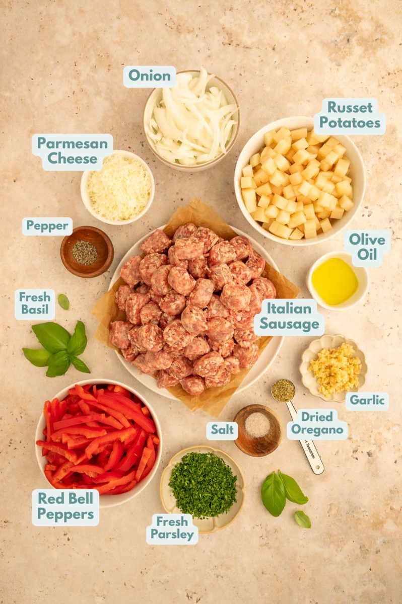 Labeled ingredients to make sheet pan Sausage, peppers, potatoes, and onions in small bowls and measuring cups.