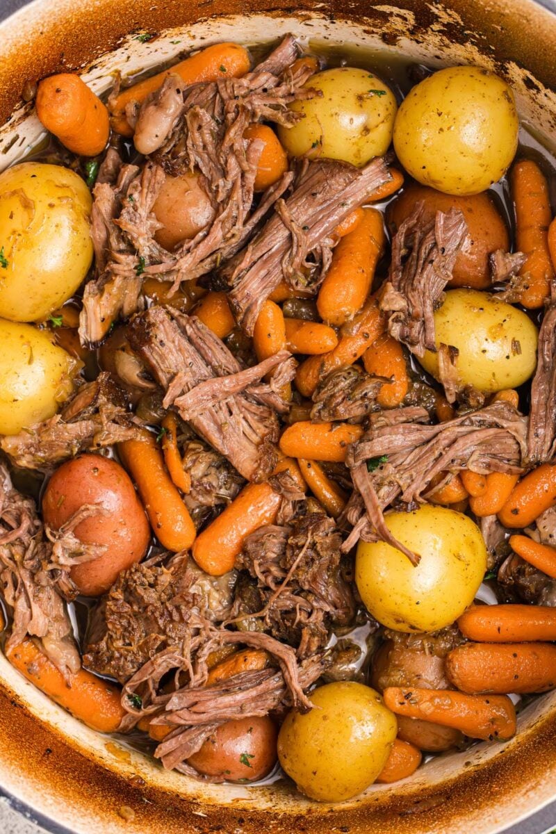 Pot Roast, Carrots, and Potatoes in a dutch oven.