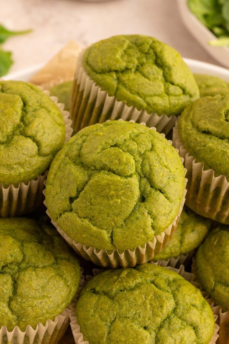 Green Muffins in a pile on a plate.