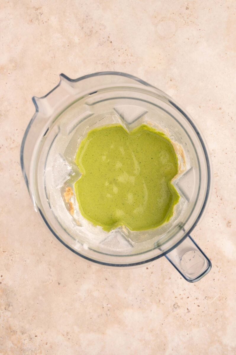 Green muffin batter in a blender after mixing together.