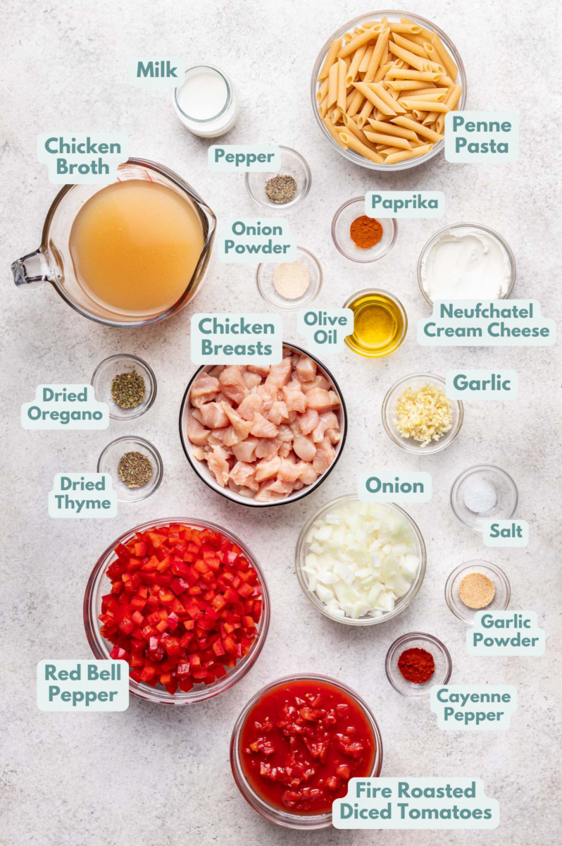 Labeled Cajun Chicken Pasta Ingredients in bowls and measuring cups on a counter.