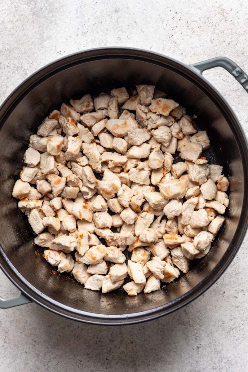 Browned chicken pieces in a large dutch oven. 