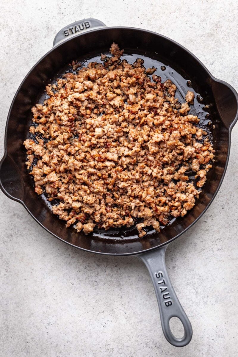 Sausage browned in a pan.